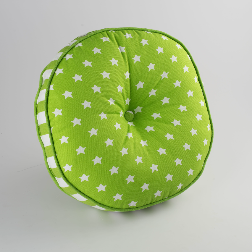Green cushion with white star pattern on a gray background