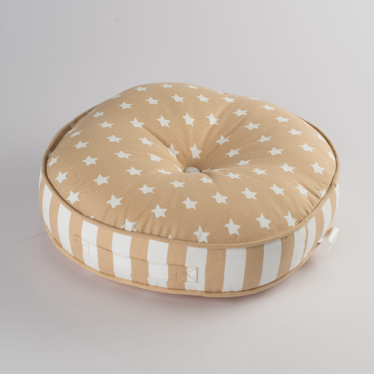 Round cushion with star pattern on a light gray background